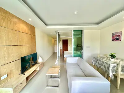 a living room with a white couch and a table at Pingping&FamilyAonang-2 in Ban Khlong Son