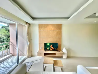 a living room with a tv and a window at Pingping&FamilyAonang-2 in Ban Khlong Son