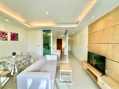 a living room with a couch and a tv at Pingping&FamilyAonang-2 in Ban Khlong Son