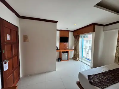 a large room with a bed and a window at Soul House Patong in Patong Beach