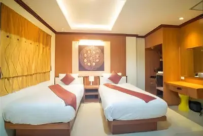 a room with two beds and a kitchen at Soul House Patong in Patong Beach