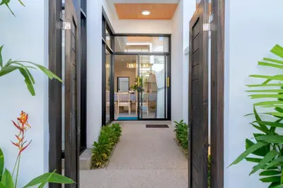a hallway of a house with plants at Villa Serana - New Private Pool Villa in Goldena Residence, Kamala in Kamala Beach