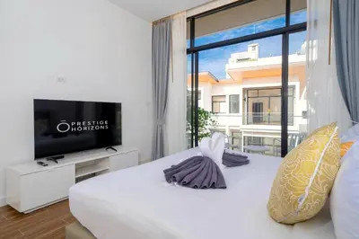 a bedroom with a white bed and a large window at Villa Serana - New Private Pool Villa in Goldena Residence, Kamala in Kamala Beach
