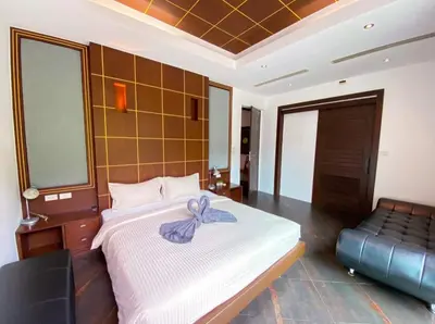 a bedroom with a bed with a purple bow on it at Villa Nature village kamala in Kamala Beach