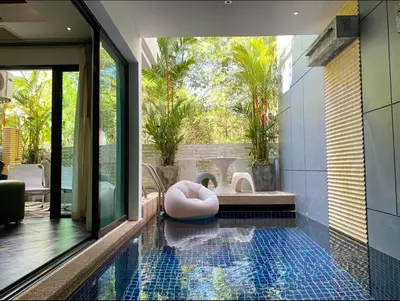a swimming pool with a pink ottoman in a bathroom at Villa Nature village kamala in Kamala Beach
