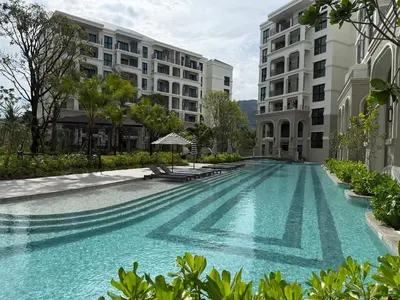 a swimming pool in front of two buildings at The Title Legendary Bang Tao - Modern 1BR Resort Apartment in Bang Tao Beach