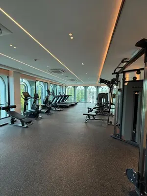 a gym with a row of treadmills and machines at The Title Legendary Bang Tao - Modern 1BR Resort Apartment in Bang Tao Beach