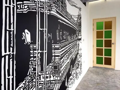 a wall with a black and white painting on it at The Pho Thong Phuket in Phuket Town
