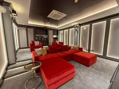 a living room with a red couch and chairs at Stylish Pool View Apartments Legendary Bangtao by Mango Family in Bang Tao Beach