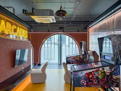 a room with a pinball machine and an arcade at Stylish Pool View Apartments Legendary Bangtao by Mango Family in Bang Tao Beach