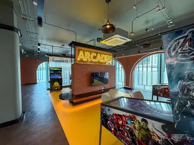 a room with a arcade with a sign on it at Stylish Pool View Apartments Legendary Bangtao by Mango Family in Bang Tao Beach