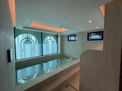 a glass room with a window in a building at Stylish Pool View Apartments Legendary Bangtao by Mango Family in Bang Tao Beach