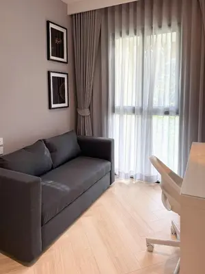 a living room with a couch and a large window at Stylish Pool View Apartments Legendary Bangtao by Mango Family in Bang Tao Beach