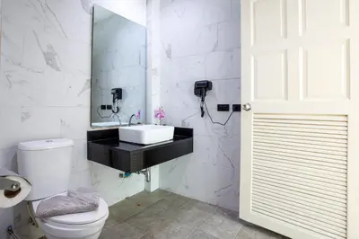 a white bathroom with a sink and a toilet at New! bayfront 2 BR Villa with private pool Nariya V1 - rare find in Phuket in Chalong