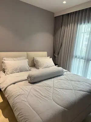 a large white bed in a room with a window at The Title Legendary Bang Tao by Tropicana Property in Bang Tao Beach