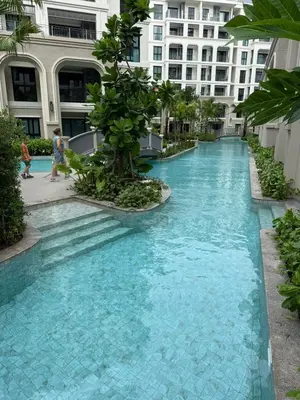 a pool in the middle of a building with blue water at The Title Legendary Bang Tao by Tropicana Property in Bang Tao Beach