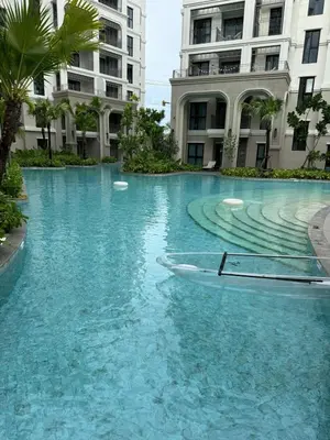 a boat in the water in front of a building at The Title Legendary Bang Tao by Tropicana Property in Bang Tao Beach