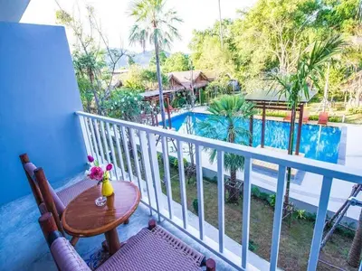 a balcony with a table and a view of a pool at Bora Bora Villa Phuket in Chalong