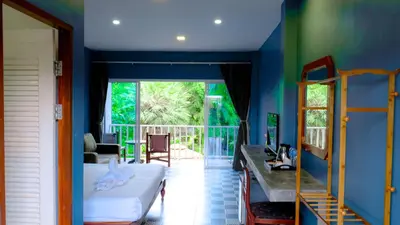 a bedroom with a bed and a balcony at Bora Bora Villa Phuket in Chalong