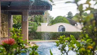 a fountain in front of a house with a swimming pool at Golfer's Getaway 7 Bedroom Pool Villa (SV1) in Phuket Town