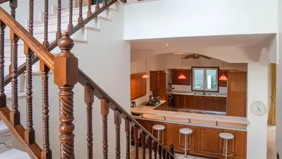 a staircase leading to a kitchen and living room at Golfer's Getaway 7 Bedroom Pool Villa (SV1) in Phuket Town