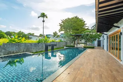 a swimming pool in the backyard of a house at Exclusive! 3-Bedroom Pool Villa with Bay View-Nariya V8 in Chalong