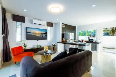 a living room with a couch and a kitchen at NEW! 3-Bedroom Pool Villa Overlooking Chalong Bay-Nariya V9 in Chalong