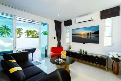 a living room with a couch and a tv at NEW! 3-Bedroom Pool Villa Overlooking Chalong Bay-Nariya V9 in Chalong
