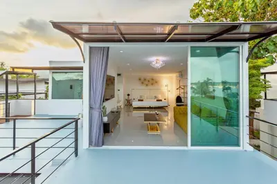 a view of the living room from the balcony of a house at NEW! 3-Bedroom Pool Villa Overlooking Chalong Bay-Nariya V9 in Chalong