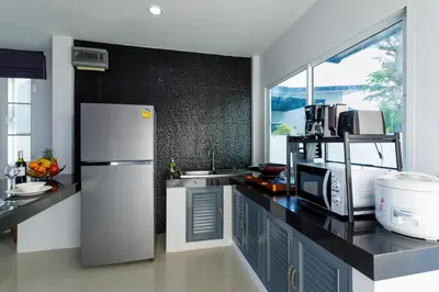 a kitchen with a refrigerator and a sink at NEW! 3-Bedroom Pool Villa Overlooking Chalong Bay-Nariya V9 in Chalong
