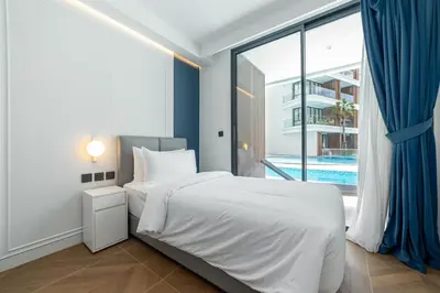 a bedroom with a bed and a window with a pool at Kora Beach Resort 3 bedroom By Ere D118 in Ko Kala