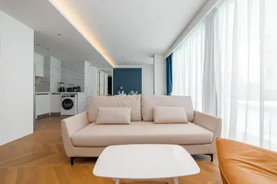 a white living room with a couch and a table at Kora Beach Resort 3 bedroom By Ere D118 in Ko Kala