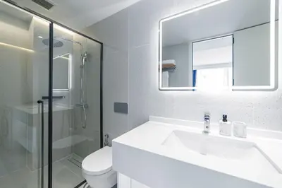 a bathroom with a sink and a toilet and a mirror at Kora Beach Resort 3 bedroom By Ere D118 in Ko Kala