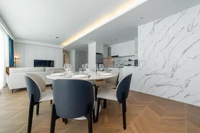 a dining room with a table and chairs and a kitchen at Kora Beach Resort 3 bedroom By Ere D118 in Ko Kala
