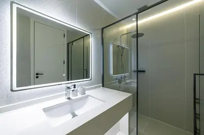 a bathroom with a sink and a mirror and a shower at Kora Beach Resort 3 bedroom By Ere D118 in Ko Kala