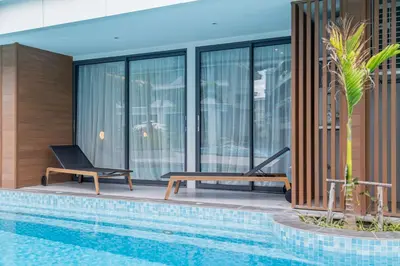 a swimming pool in front of a building at Kora Beach Resort 3 bedroom By Ere D118 in Ko Kala