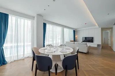 a dining room with a white table and chairs at Kora Beach Resort 3 bedroom By Ere D118 in Ko Kala
