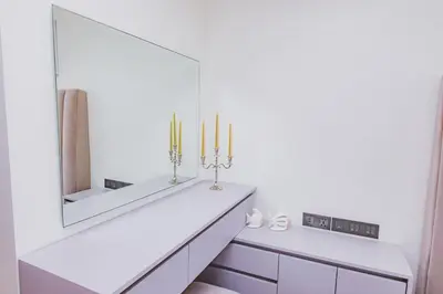 a white bathroom with two candles and a mirror at Luxury Angsana Residence in Bang Tao Beach