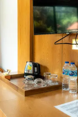 a table with glasses and a radio and bottles of water at Chabana Resort Bang-tao Beach Phuket- SHA Extra Plus in Bang Tao Beach
