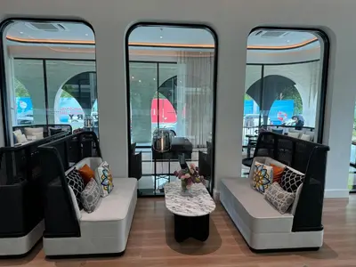 a room with two chairs and a table and windows at Апартаменты у океана пляж Бангтао Title Legendary Bangtao in Bang Tao Beach
