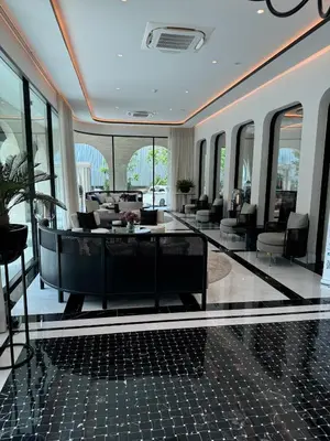 a lobby with couches and tables and windows at Апартаменты у океана пляж Бангтао Title Legendary Bangtao in Bang Tao Beach