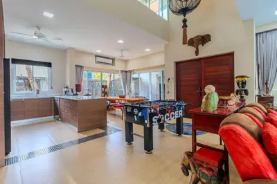 a living room with a game table and a kitchen at V256 Huge Modern 10BR ZipLine 3 Pools Fully Loaded in Rawai Beach