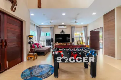 a living room with a large table in the middle of a room at V256 Huge Modern 10BR ZipLine 3 Pools Fully Loaded in Rawai Beach