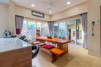 a kitchen and dining room with a wooden table at V256 Huge Modern 10BR ZipLine 3 Pools Fully Loaded in Rawai Beach