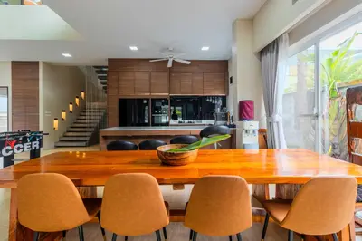 a dining room with a wooden table and chairs at V256 Huge Modern 10BR ZipLine 3 Pools Fully Loaded in Rawai Beach