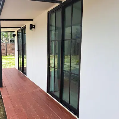 an external view of a house with black windows at Seashell Family-555\u666e\u5409\u5c9b\u6728\u5c4b\u8d70\u51e0\u6b65\u5230\u90a6\u6d9b\u6d77\u6ee9\u770b\u65e5\u843d\u5468\u8fb9\u9910\u996e\u65b9\u4fbf in Bang Tao Beach