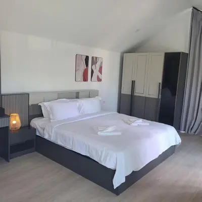 a bedroom with a large bed with two towels on it at Seashell Family-555\u666e\u5409\u5c9b\u6728\u5c4b\u8d70\u51e0\u6b65\u5230\u90a6\u6d9b\u6d77\u6ee9\u770b\u65e5\u843d\u5468\u8fb9\u9910\u996e\u65b9\u4fbf in Bang Tao Beach