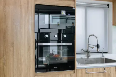 a black microwave in a kitchen with a sink at V257 Spacious 5BR Villa Waterfall Pool Movie Room in Rawai Beach