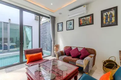 a living room with a couch and a table at V257 Spacious 5BR Villa Waterfall Pool Movie Room in Rawai Beach
