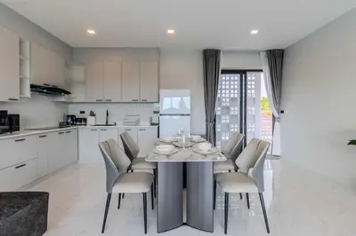 a kitchen with a table and chairs in a kitchen at V258 2 Villas 2 Kitchens 2 Livingrooms Huge Pool in Rawai Beach